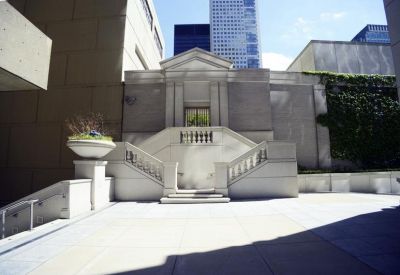 Outdoor plaza with a classic stone staircase and ivy-covered walls.