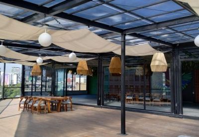 Open outdoor area with canopy and hanging lights.