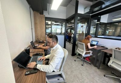 Open-plan office space with multiple desks.