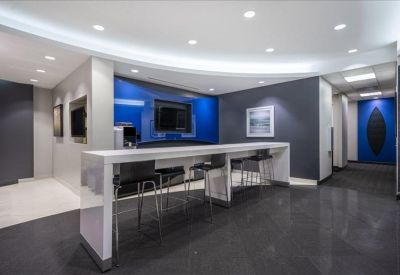 Modern breakroom area with a long white breakfast bar and blue feature lighting.