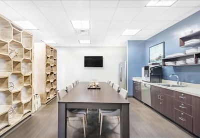 Spacious communal kitchen and dining area with honeycomb shelving and modern cabinetry.