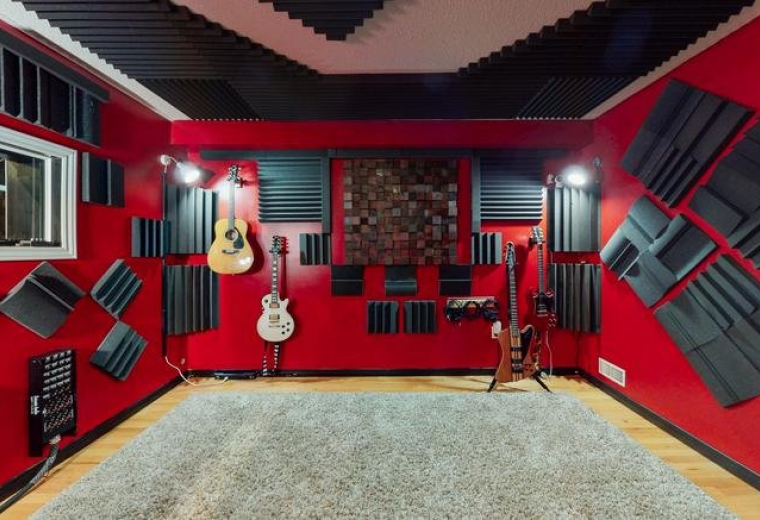 Spacious music studio at 10 Lisa Court, London (Ontario) with red walls and various guitars.