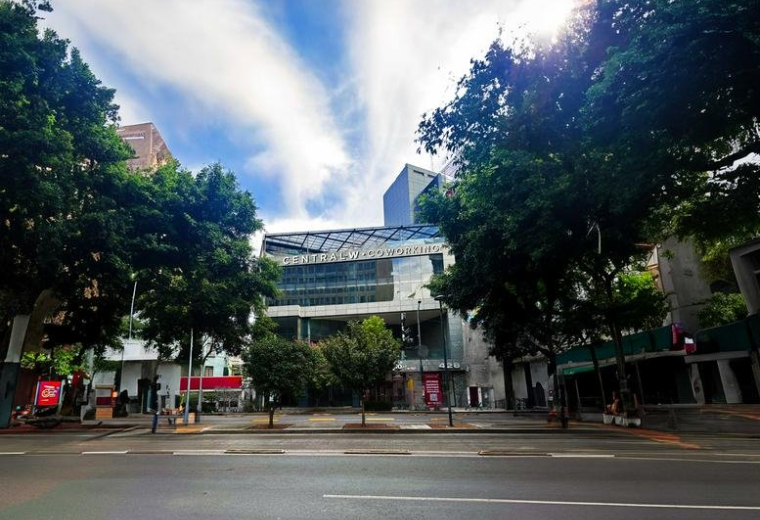 Street view of a modern office building with trees around.