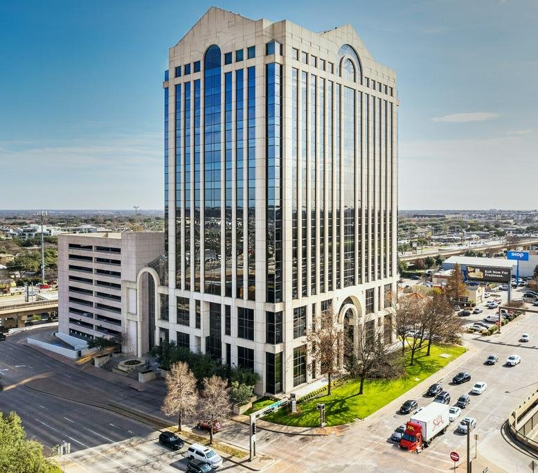 Exterior view of the multi-story stone and glass building at 8080 N Central Expressway.