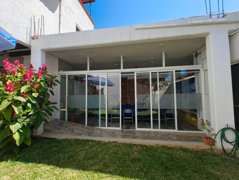 Exterior view showing glass sliding doors and a green lawn area.