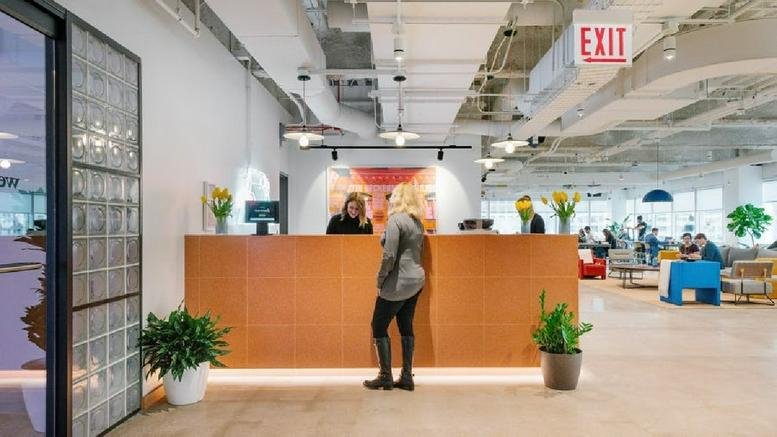 Spacious reception area with a wood-paneled desk and warm lighting at 515 N. State Street.