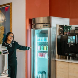 Office breakroom area featuring a glass-door beverage fridge and coffee station.