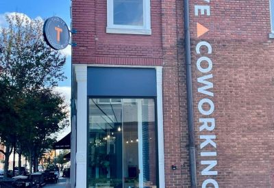Brick exterior facade featuring Thrive Coworking signage.