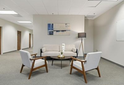 Lobby waiting area with modern armchairs and a small coffee table.