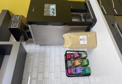 Kitchen area with a professional espresso machine and coffee supplies.
