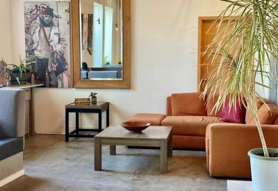 Modern architectural interior featuring a wide wooden staircase and vibrant colored lighting.