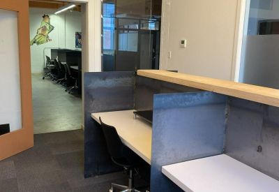 Private glass-walled call booths with colorful geometric decals and individual seating.