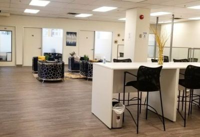 Open communal area with high-top tables, bar stools, and soft lounge seating.