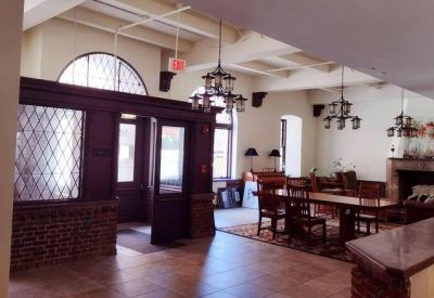 Grand historic lobby with dark wood entrance and vaulted ceilings.