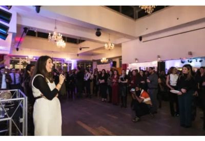 Spacious event venue filled with guests during a presentation.