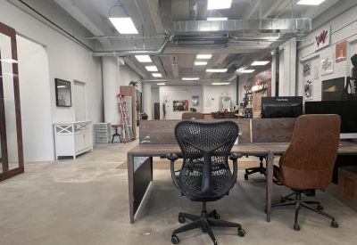 Open-plan office with ergonomic chairs and natural light from large windows.