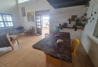 Spacious communal area with a large dark wood table and high ceilings.