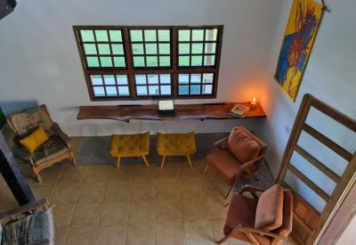 Bright workspace featuring a long wooden floating desk and various armchairs.