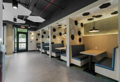 Sleek dining booths with blue upholstery and geometric wall patterns.