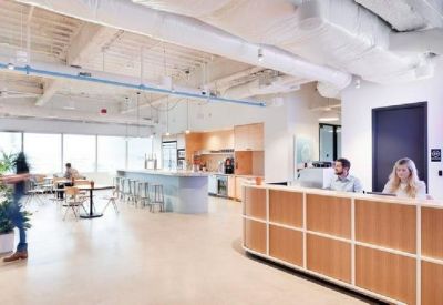 Bright reception area featuring a light wood desk and a spacious entryway.