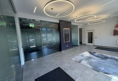 Modern reception lobby with circular light fixtures and a patterned area rug.