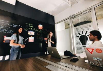 Creative meeting space with a chalkboard wall and lightbulb graphic.