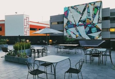 Modern conference room with a long wood table and dark accent walls.
