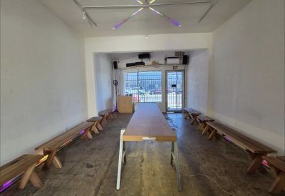 Long wooden meeting table flanked by benches under a starburst ceiling light.