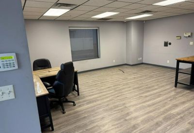 Spacious interior office at 983 East 73rd Avenue, Unit A, Denver, Colorado with wood-look flooring and L-shaped desk.