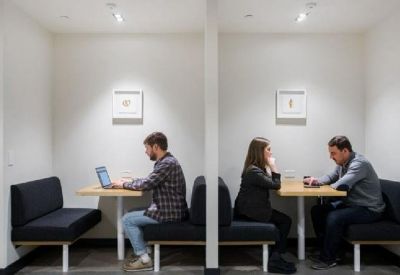 Private work booths with individual tables and black seating for focused tasks or meetings.