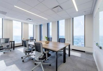 Bright conference room with a large wooden table and floor-to-ceiling windows.