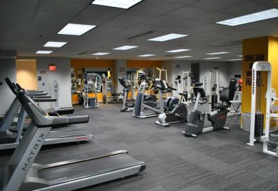 Spacious on-site fitness center with treadmills, stationary bikes, and weight machines.