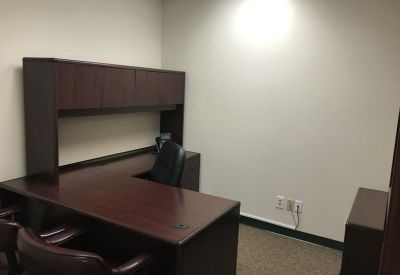 Private office suite featuring dark wood L-shaped desk at 10015 Old Columbia Rd, Suite B215, Columbia.