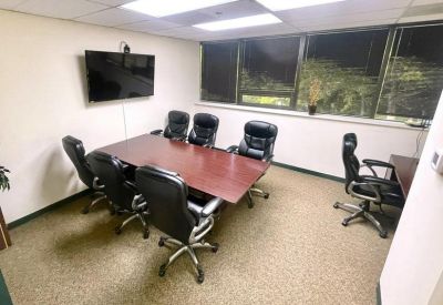 Meeting room with wooden table and black leather chairs at 10015 Old Columbia Rd, Suite B215, Columbia.