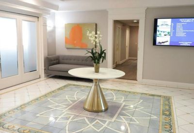 Modern reception area with a central round table and artwork.