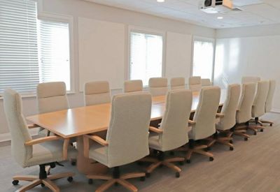 Large boardroom with a long table and projector.