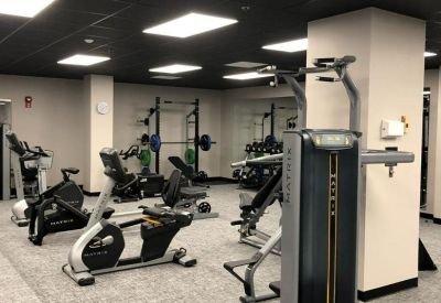 Fitness center with various exercise bikes and strength training equipment.