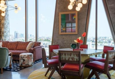 Spacious lounge area featuring a velvet sofa and patterned armchairs.