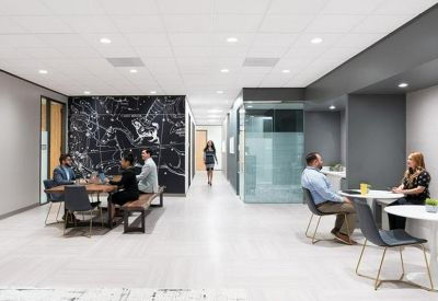 Spacious communal lounge featuring a celestial mural wall and various seating areas.