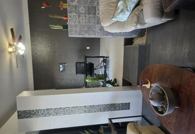 Private office featuring a tiled divider wall and dark accent wall.