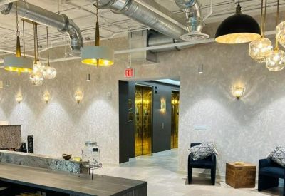 Modern reception area with decorative pendant lighting and an elevator bank entrance.
