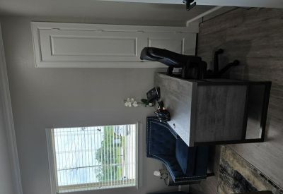 Private office with a wooden desk and blue velvet chair.