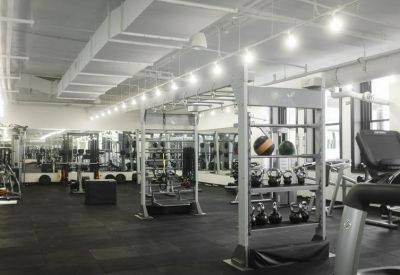 Modern gym facility with weight racks and medicine balls.