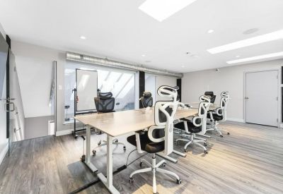 Meeting room with a large rectangular table and white ergonomic chairs.