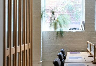 Minimalist hallway featuring tall wooden doors with glass panels.