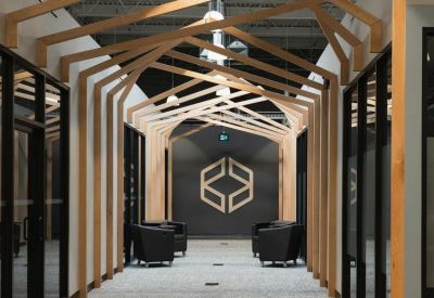 Hallway featuring a unique arched wooden beam structure leading to a branded lounge area.