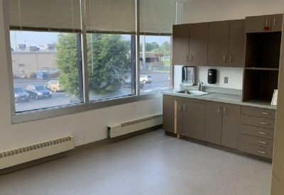 Clinical private office space featuring built-in cabinetry and a sink.