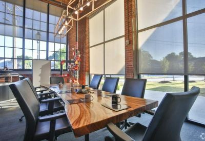 Reception area featuring a wooden front desk and a lush green living wall.