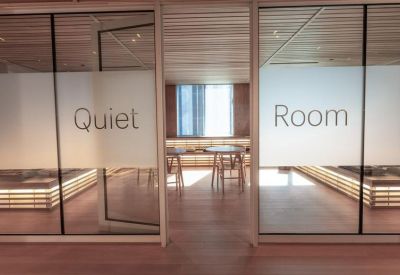 Frosted glass doors leading to a quiet room with wooden interior accents.