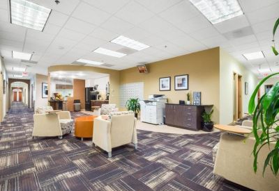 Open communal lounge area with plush armchairs and a coffee station.